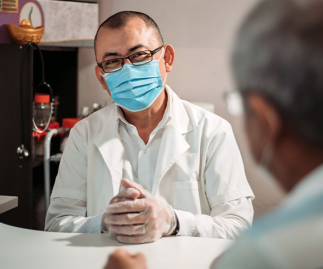 A medical provider discusses COVID vaccination options with a patient.
