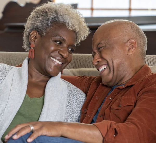 Retired couple smiling about how easy MyGeisinger is to use