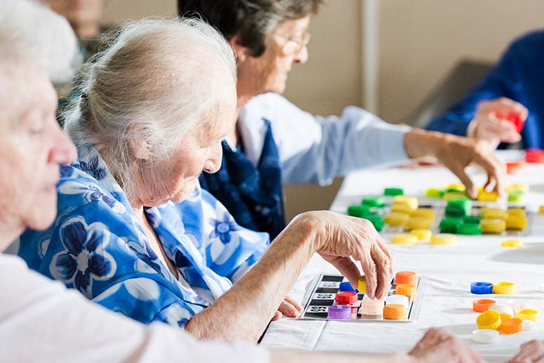 Elderly women playing bingo at a local seniors center.