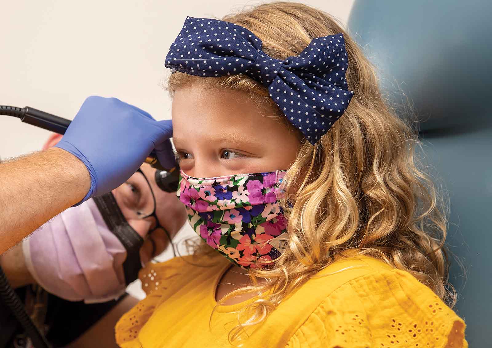 A young female patient receives a medical examination from her healthcare provider.