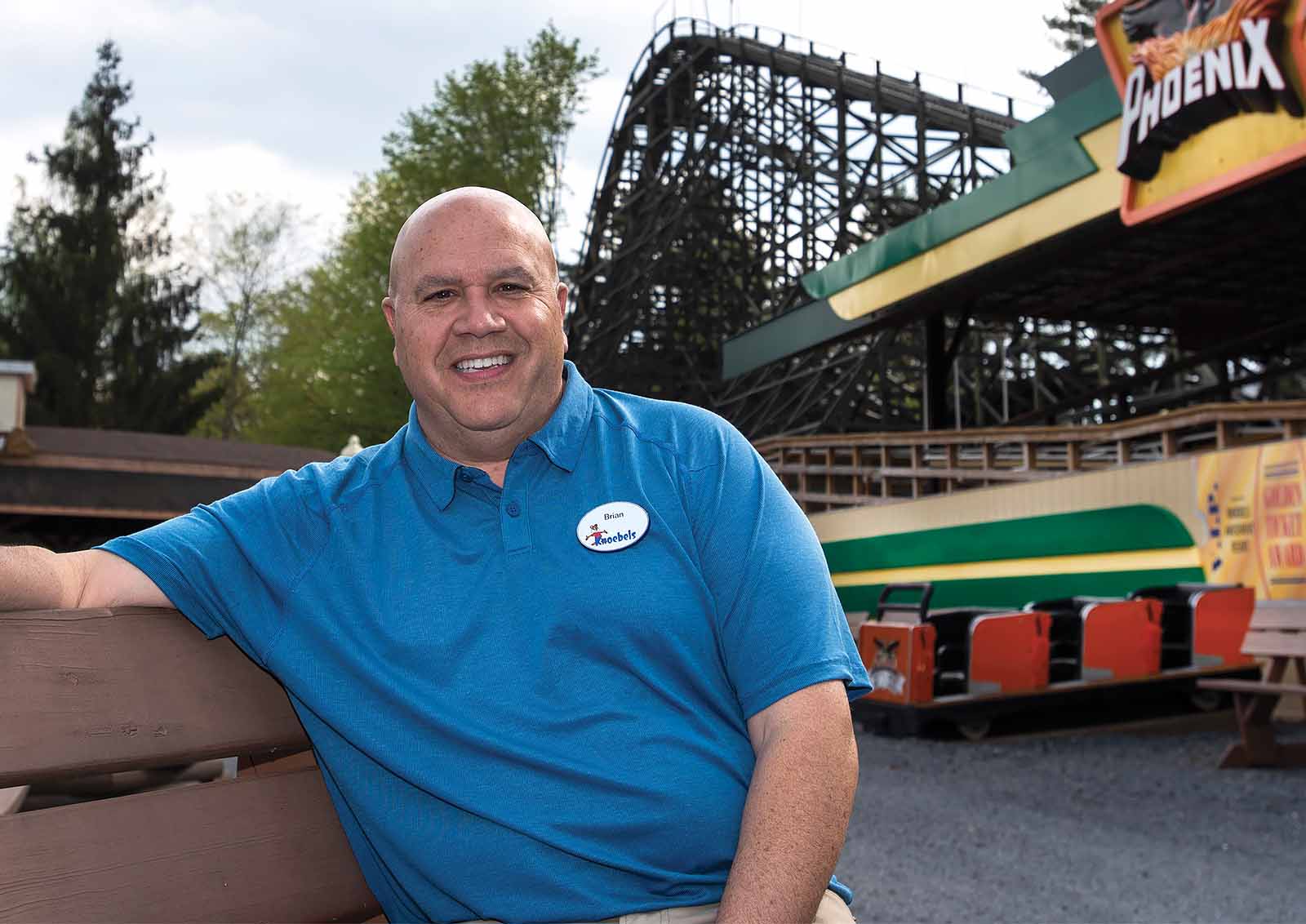 Brian Knoebel sits on a park bench in his family-owned amusement park in Elysburg, PA.