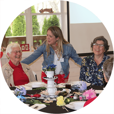 Women gather a luncheon to celebrate service awards.