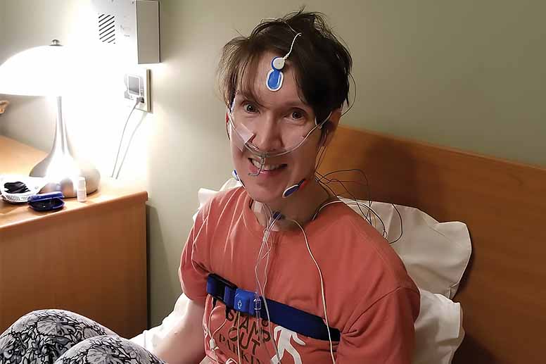 Female patient connected to leads prepares for a night in the Geisinger sleep lab.