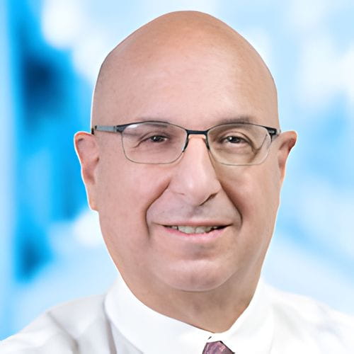 Headshot of Dr Avetian on white and blue background