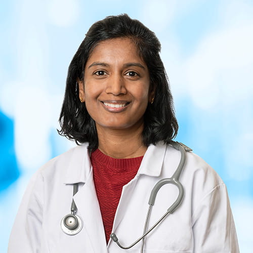 Headshot of Dr Sadasivan on white and blue background