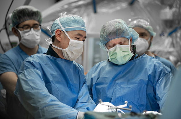 Two doctors doing a surgical procedure