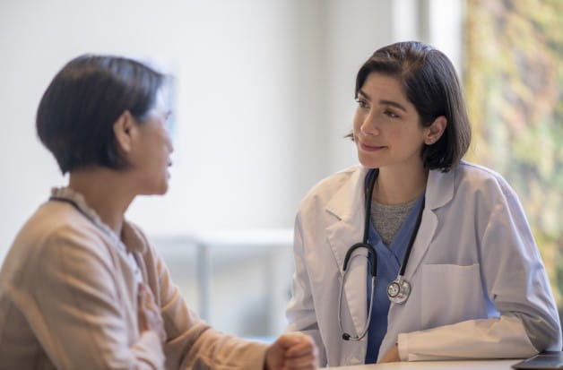 A doctor talking to an older female patient