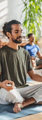 A man meditates during a yoga course