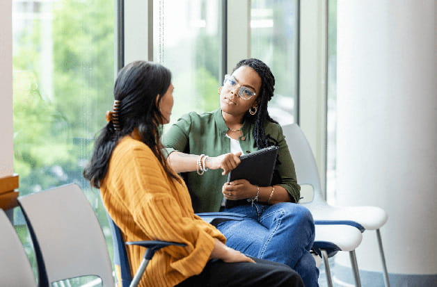 A patient chats with a case manager in a primary care office