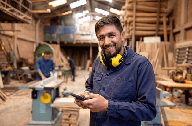 A construction contractor texts while on a work site