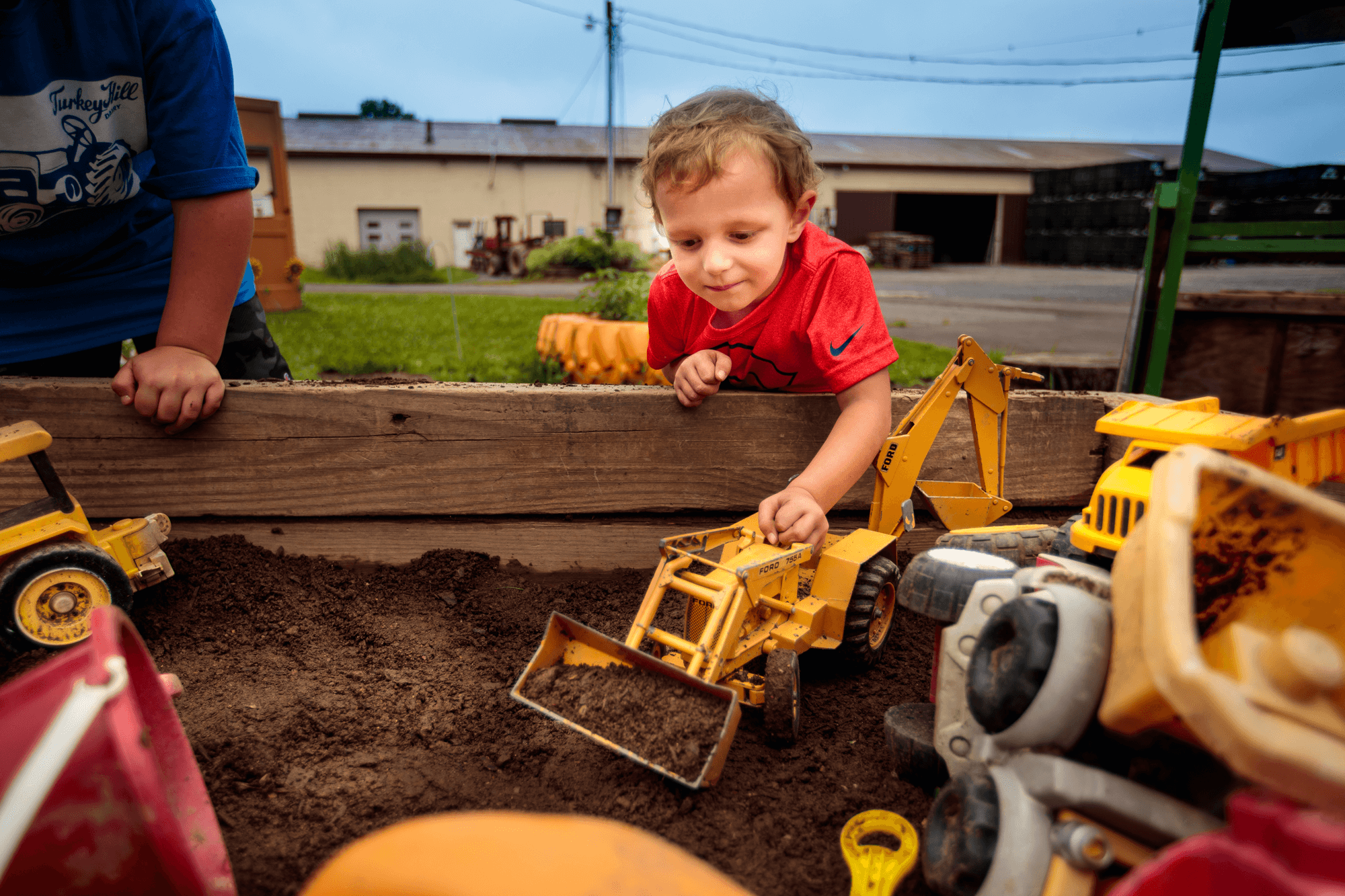 Parent watching their kid(s) playing with other children at a park