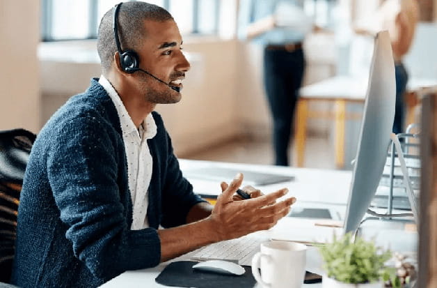 A worker is helping set up a primary care appointment over the phone