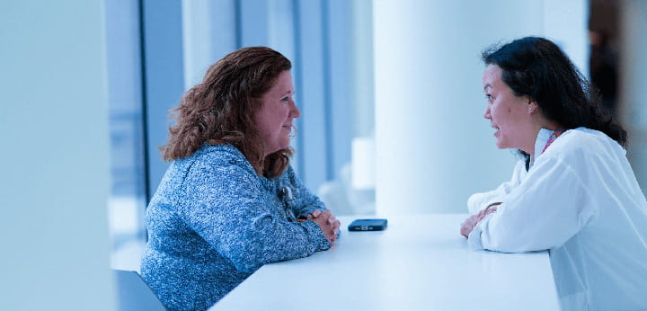 A doctor sitting at a table with a patient