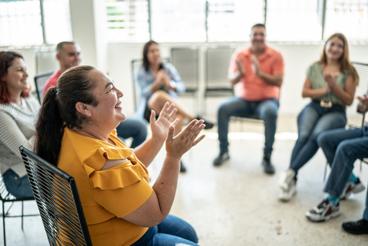 A goup of adults talking in a circle