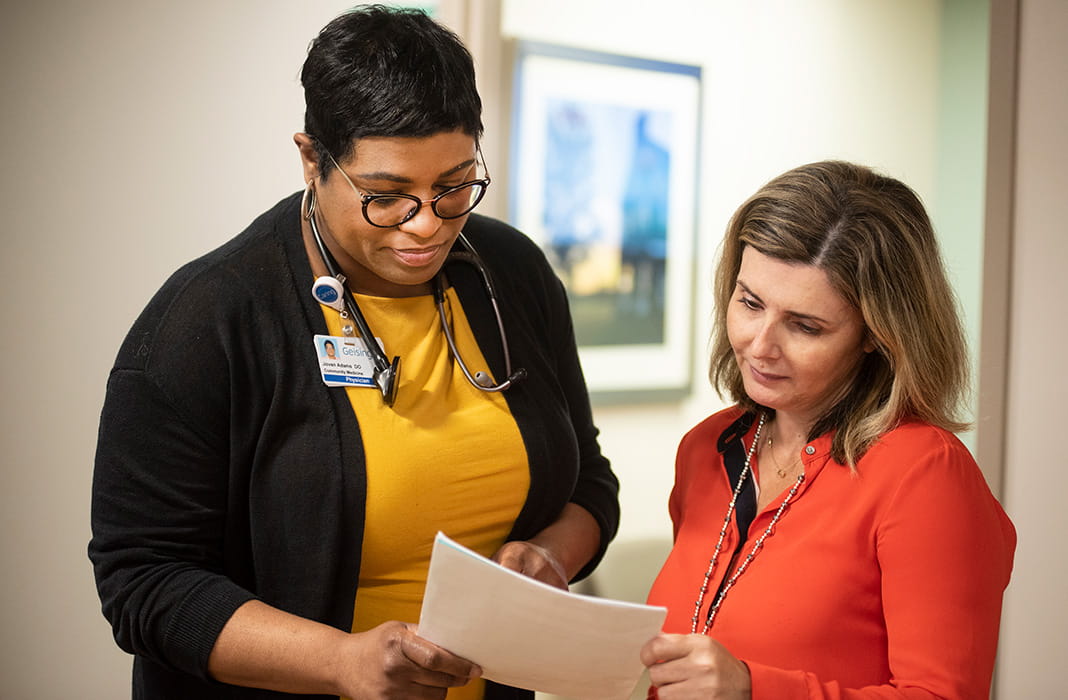 Doctor showing records to patient