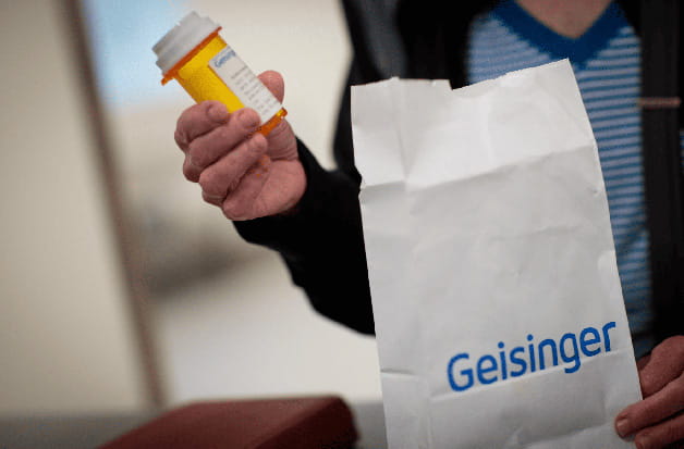 A person holding a prescription bottle