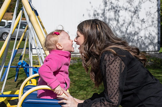 A senior man playing ping pong with a younger man