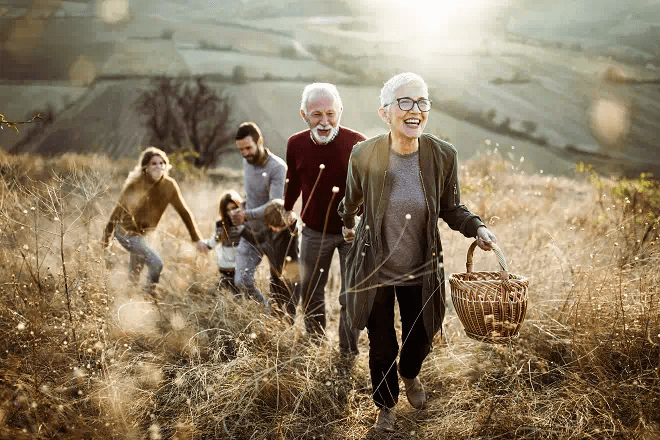 An elderly couple on a hike with their family