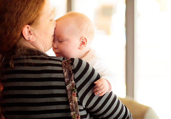 A mother holding her baby