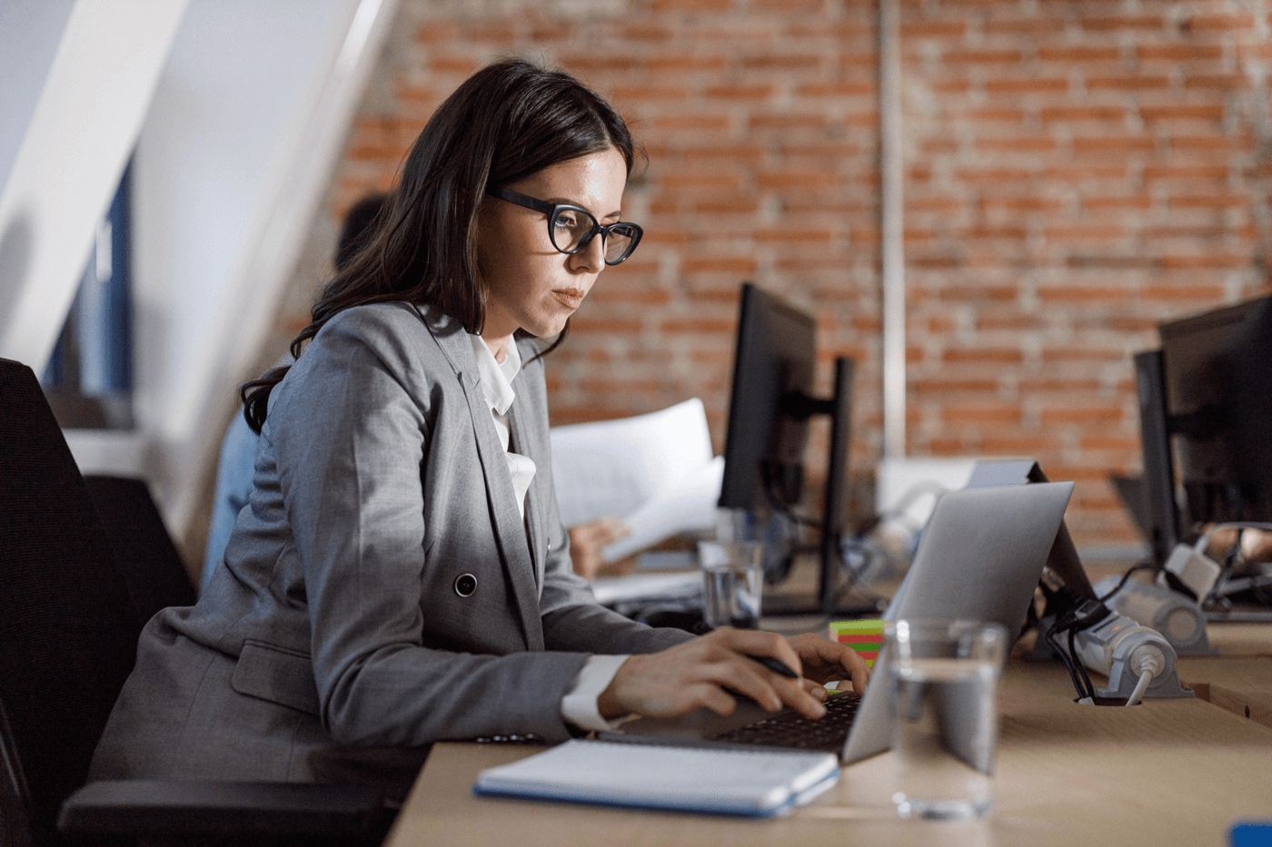 A woman works in an office on her laptop
