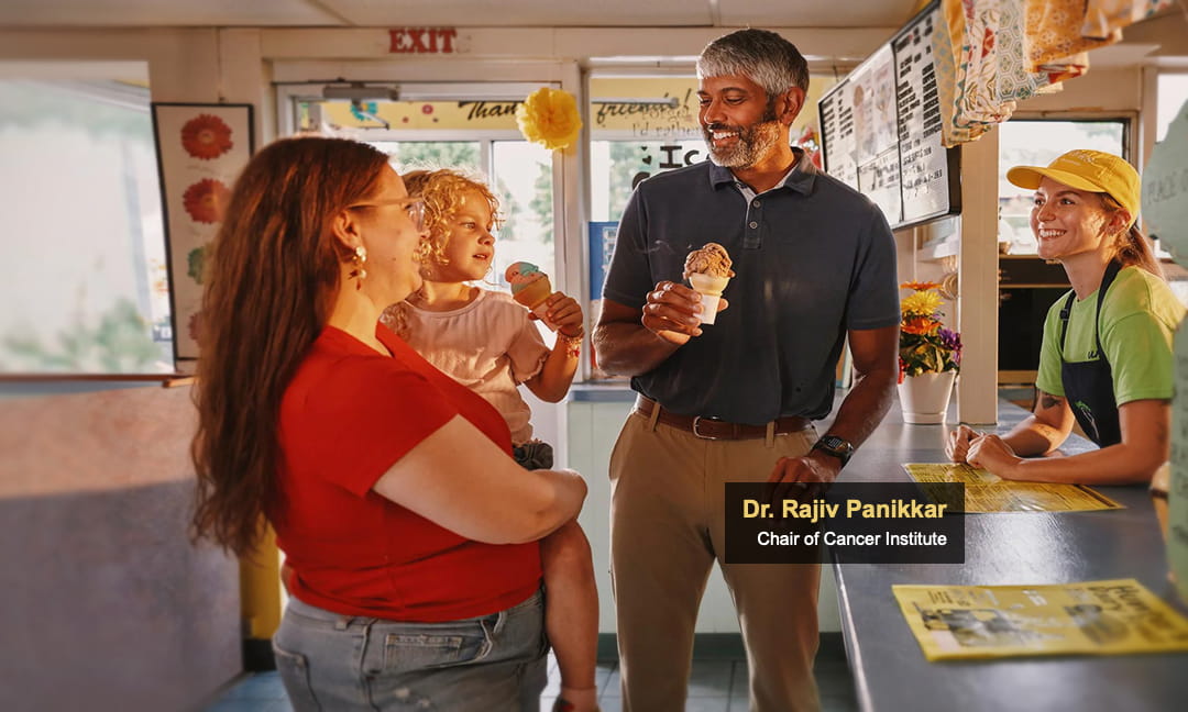 Dr. Panikkar with ice cream and child