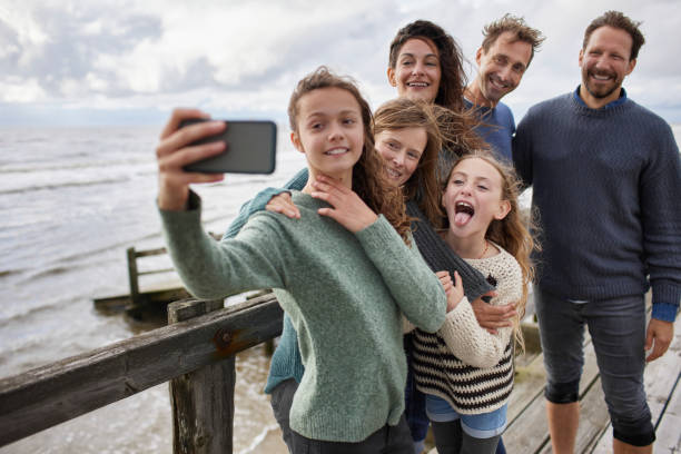 A family taking a selfie at the beach