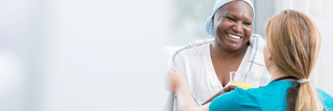 cancer patient smiling with nurse