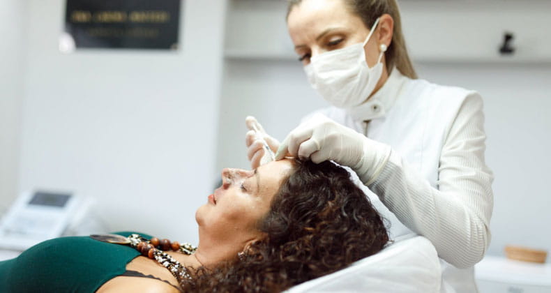 an image of a dermatologist giving an injection to a patient