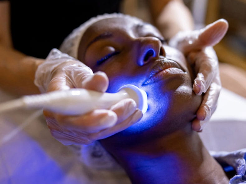 a patient getting a dermatology treatment to their face