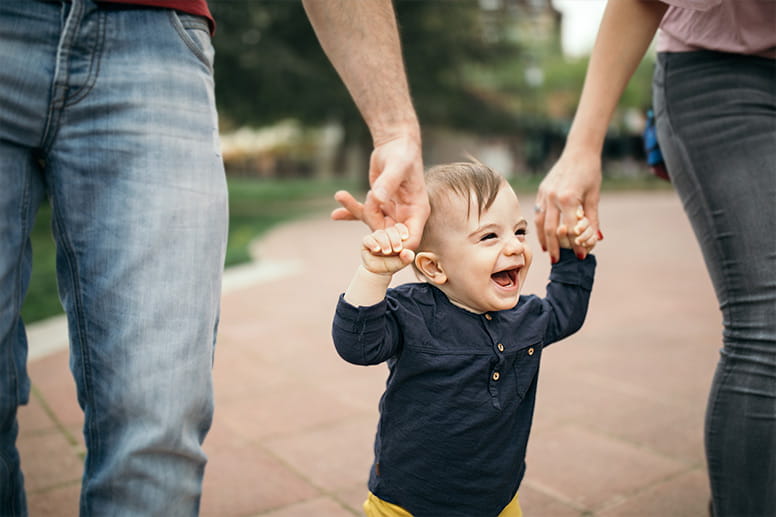 A photo of father and son making first walk