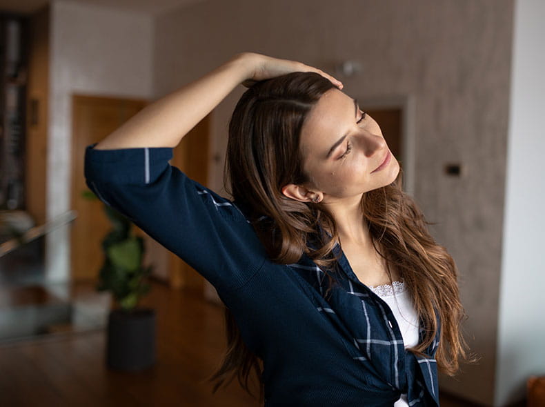a woman doing a neck stretch