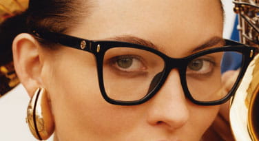 a woman wearing black glasses