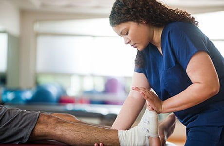 a physical therapist helping a patient