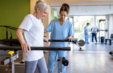 a female physical therapist helping a patient with rehab