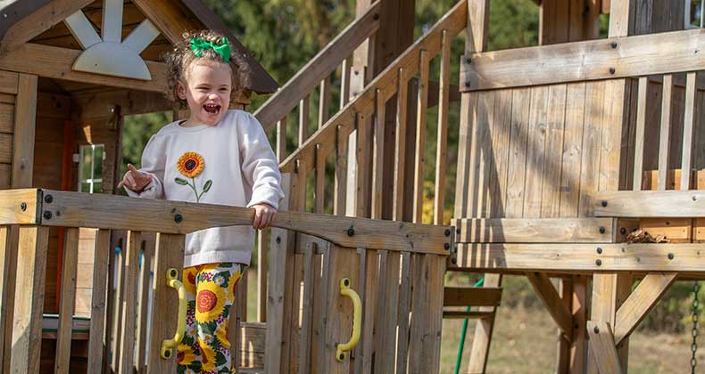 Cordelia Scott plays on a wooden playground