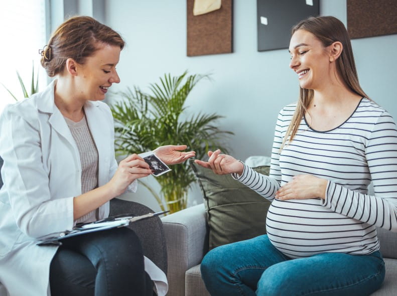 a young woman meeting with a midwife