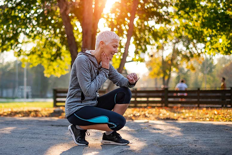 Senior Athletic Woman Checking Heart Rate After Running in the Park