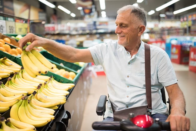 A man in a wheelchair shopping for groceries