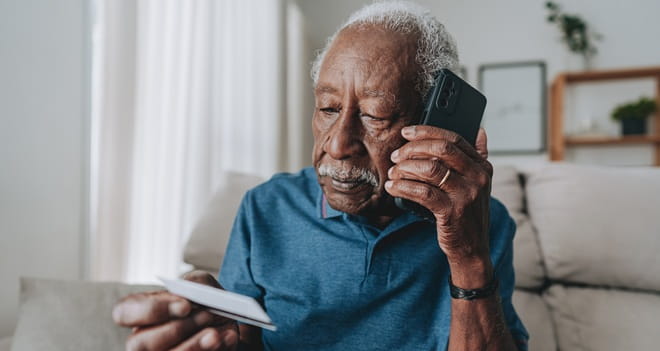 Senior on the phone holding mail