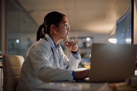 A doctor looking at her computer