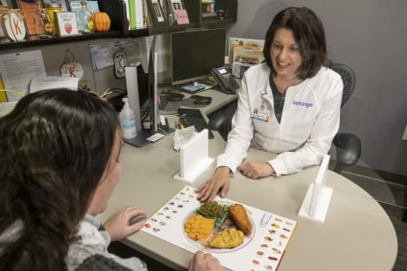 an image of two people discussing food options