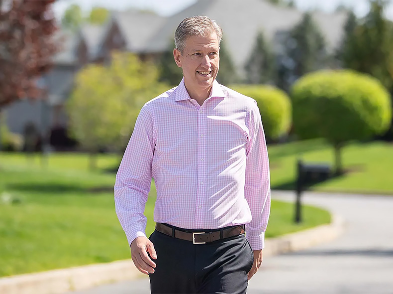 Person walking outdoors in a residential neighborhood, representing an active lifestyle and community wellness.