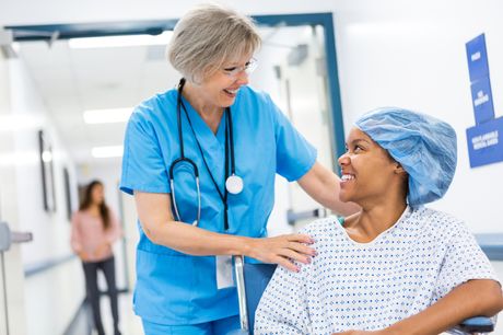 Surgeon with patient, smiling before surgery.