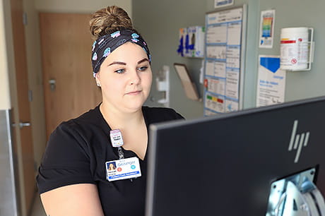 Future nurse Hannah Leach records a patient's vital signs into the hospital computer.