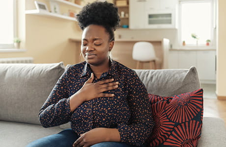 an image of a woman holding her chest
