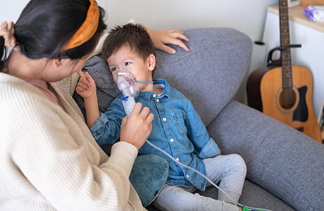 A child getting a breathing treatment for his cystic fibrosis