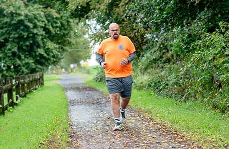A man outside running preparing for weight loss surgery.