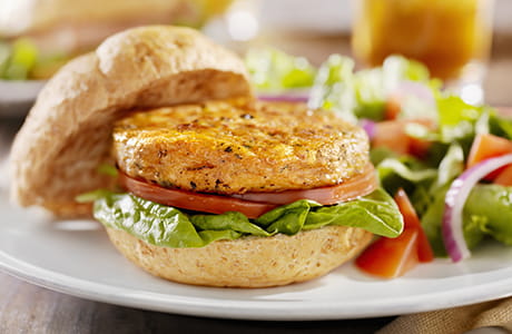 A vegetarian Soy Burger with Spinach Tomatoes