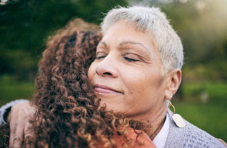 Two women embracing one another. 