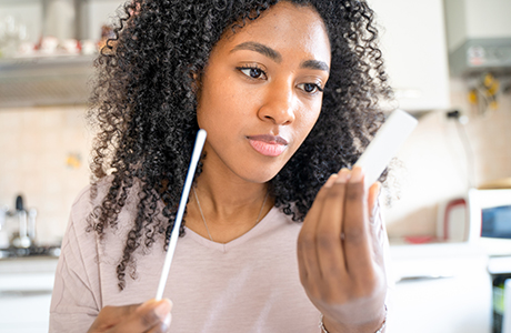 A young woman looks at a lab kit